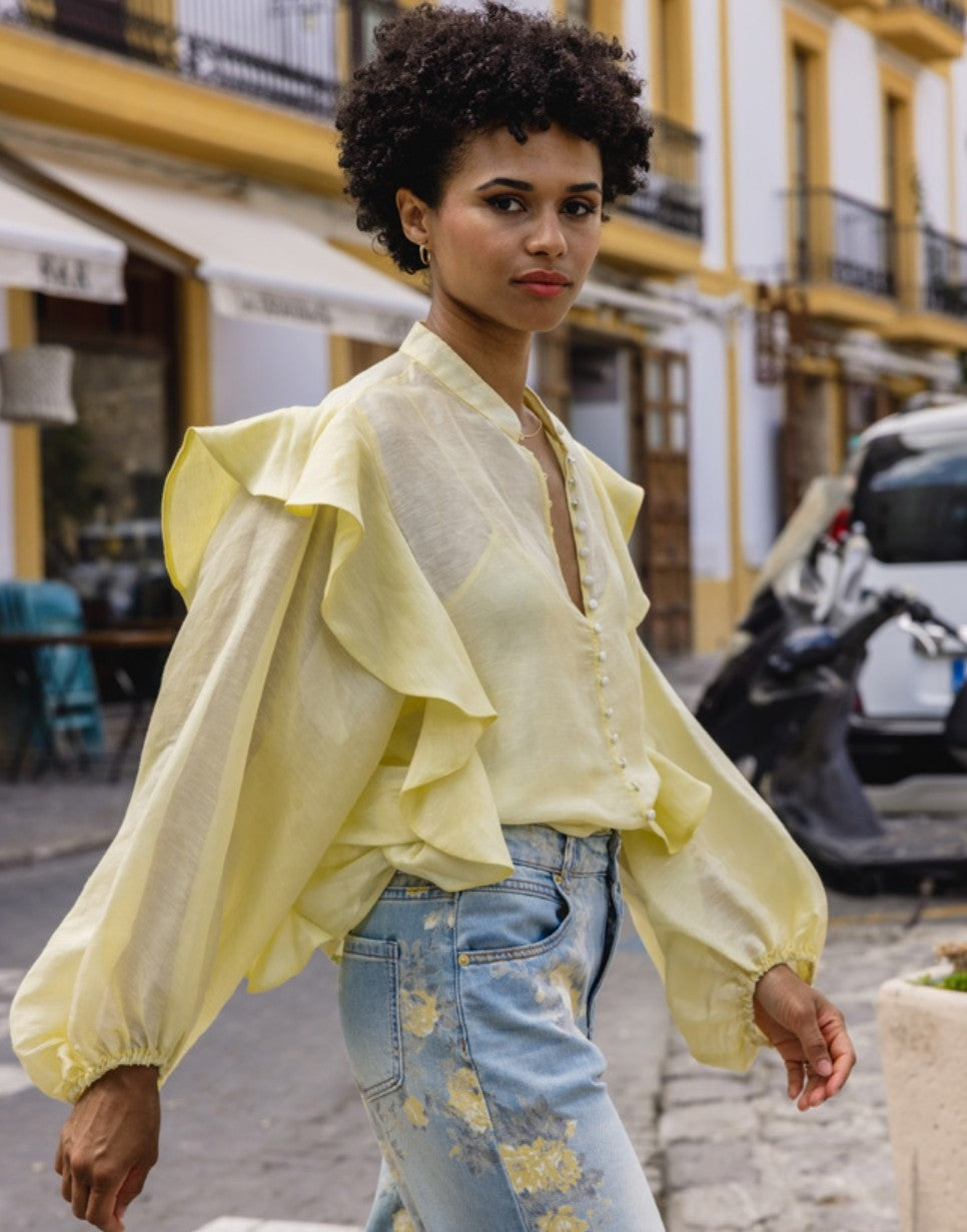 SS26 campaign — ruffled blouse on an Ibiza street